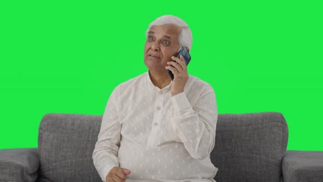 Angry-Indian-old-man-talking-on-phone-Green-screen