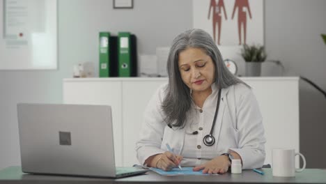 Indian-female-senior-doctor-giving-medicine-to-the-patient