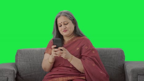 Happy-Indian-old-woman-chatting-on-phone-Green-screen