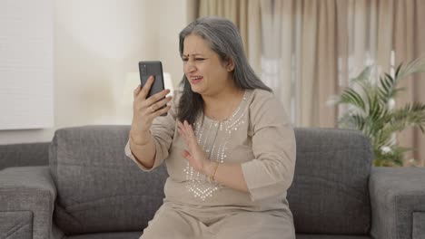 Happy-Indian-old-woman-talking-on-video-call