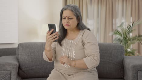 Indian-old-woman-scrolling-phone