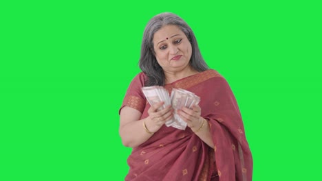 Cheerful-Indian-old-woman-counting-money-Green-screen