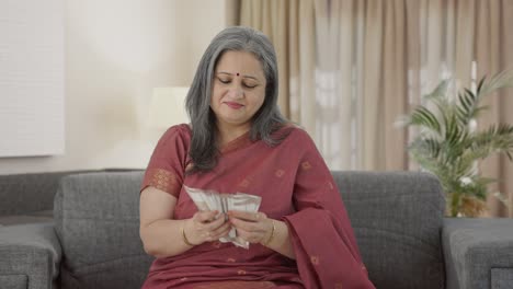 Happy-Indian-old-woman-counting-money