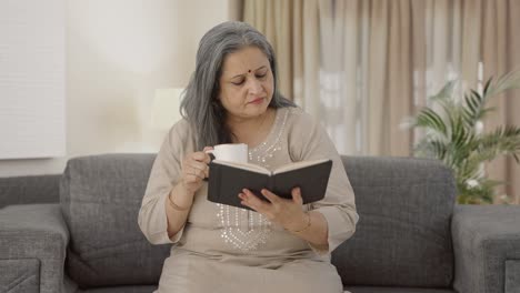 Indian-old-woman-reading-a-book-in-morning