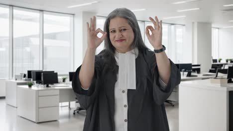 Happy-Indian-senior-female-lawyer-showing-okay-sign