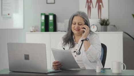 Happy-Indian-senior-female-doctor-consulting-patient-on-call