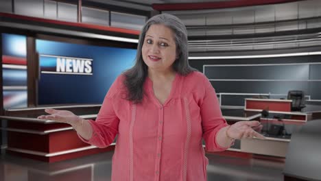 Happy-Indian-senior-female-journalist-reading-news