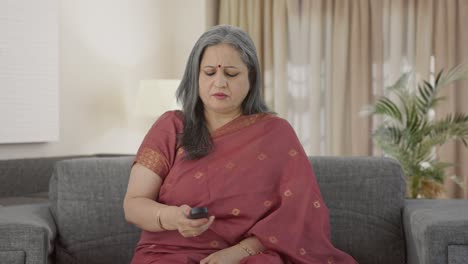 Sad-Indian-old-woman-watching-TV