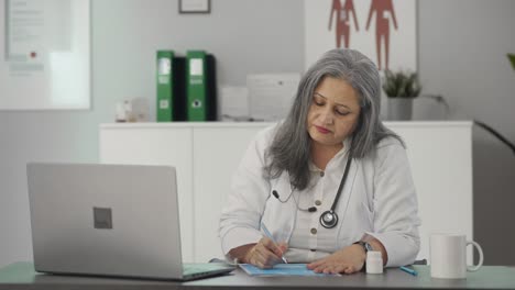 Angry-Indian-female-senior-doctor-giving-medicine-to-the-patient