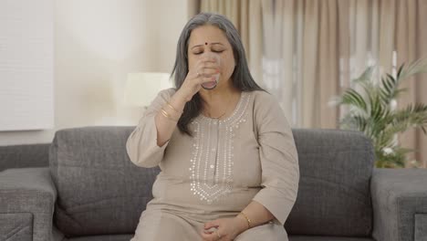 Indian-old-woman-taking-medicine