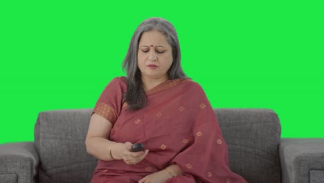 Sad-Indian-old-woman-watching-TV-Green-screen