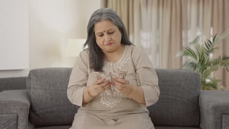 Indian-old-woman-counting-money