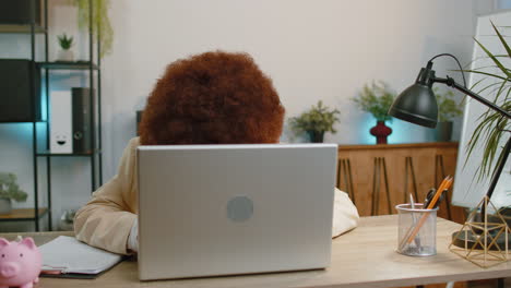 Overworked-tired-freelance-businesswoman-works-on-laptop-showing-inscription-notebook-with-Help-text