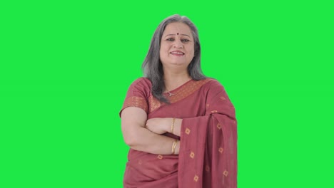 Happy-Indian-old-woman-standing-crossed-hands-Green-screen