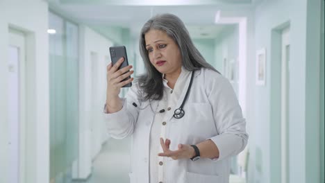 Indian-senior-female-doctor-talking-on-video-call