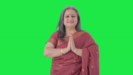 Happy-Indian-old-woman-doing-Namaste-and-greeting-guests-Green-screen