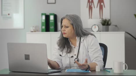 Angry-Indian-female-senior-doctor-talking-to-patient-on-video-call