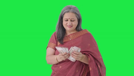 Happy-Indian-old-woman-counting-money-Green-screen