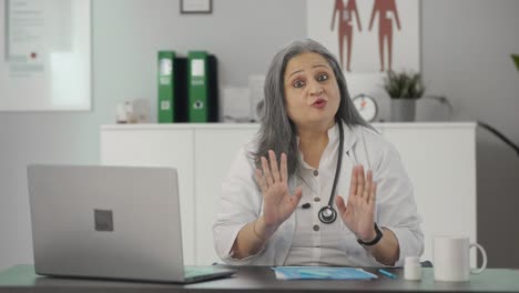 Happy-Indian-senior-female-doctor-talking-to-the-patient