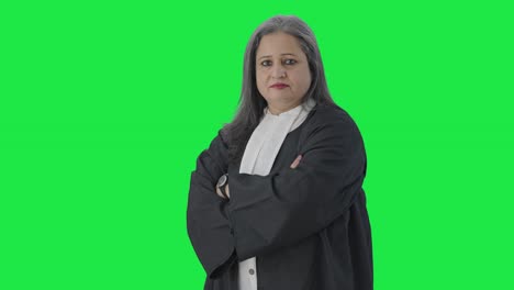 Portrait-of-Indian-senior-female-lawyer-standing-crossed-hands-Green-screen