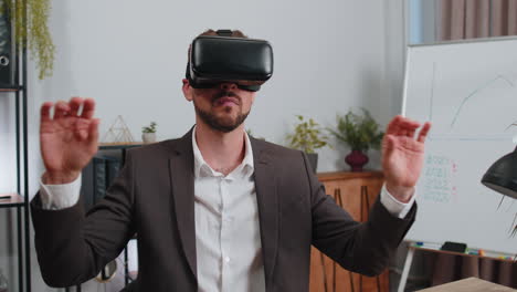 Businessman-working-using-virtual-reality-futuristic-technology-VR-app-headset-helmet-at-home-office