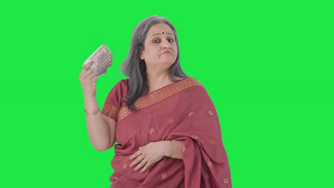 Confident-Indian-old-woman-using-money-as-fan-Green-screen