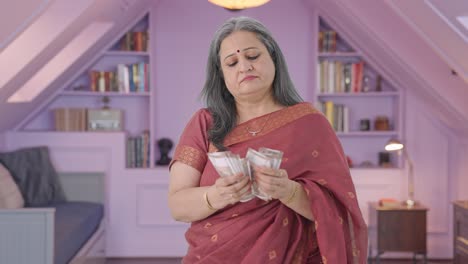 Indian-old-woman-counting-money