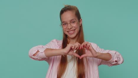 Smiling-lovely-pretty-teen-girl-makes-heart-gesture-demonstrates-love-sign-expresses-good-feelings