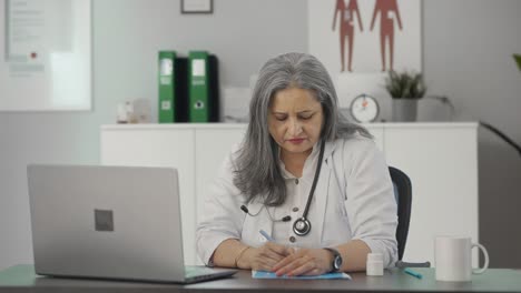 Indian-female-senior-doctor-talking-to-patient-on-video-call