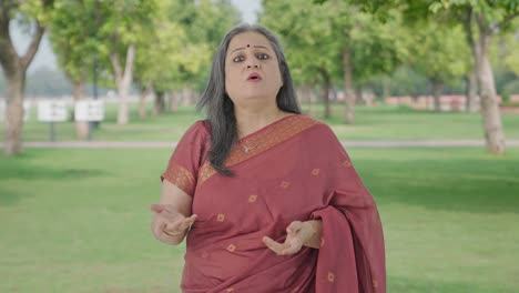 Indian-old-woman-talking-to-the-camera-in-park