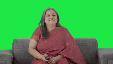 Happy-Indian-old-woman-watching-TV-and-laughing-Green-screen