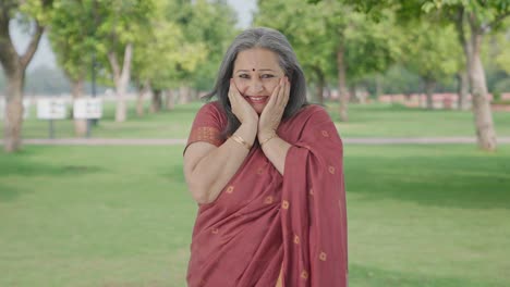 Happy-Indian-old-woman-getting-a-surprise-in-park