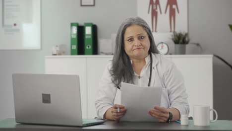 Serious-Indian-senior-female-doctor-talking-to-the-camera