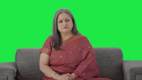 Serious-Indian-old-woman-looking-Green-screen