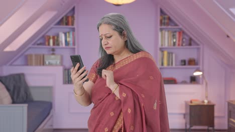 Indian-old-woman-scrolling-through-phone