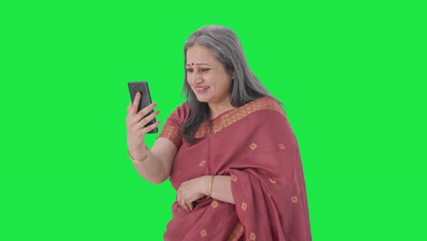 Happy-Indian-old-woman-talking-on-video-call-Green-screen