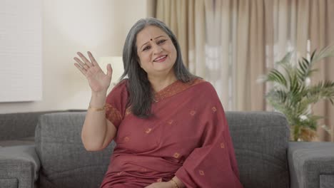 Happy-Indian-old-woman-saying-Hello-and-waving-hand