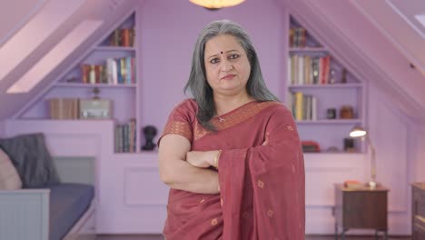 Confident-Indian-old-woman-standing-crossed-hands