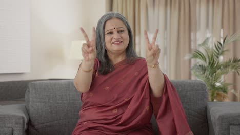 Happy-Indian-old-woman-showing-victory-sign