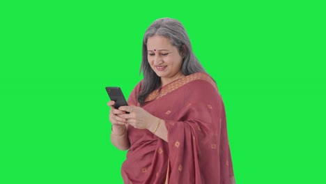 Happy-Indian-old-woman-chatting-on-phone-Green-screen