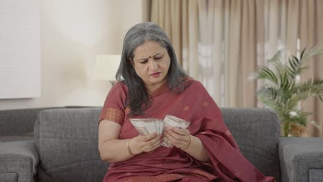 Indian-old-woman-counting-money