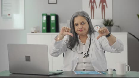 Disappointed-Indian-senior-female-doctor-showing-thumbs-down