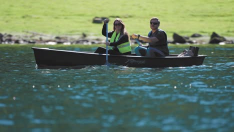 A-close-up-shot-of-the-young-couple-in-the-canoe-paddling-in-the-Naeroyfjord