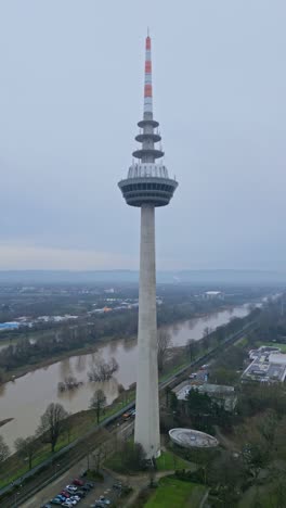 Aerial-semi-orbit-vertical-drone-view-of-Telecomunications-Television-Tower-in-Mannheim,-Baden-Württemberg,-Germany-on-a-beautiful-cloudy-sky