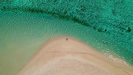 4K-drone-video-of-a-couple-laying-on-the-soft-white-sand-at-a-beach-in-the-Cape-Range-National-Park-in-Western-Australia