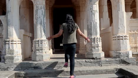 young-girl-at-historic-fort-temple-entrance-at-morning-from-flat-angle