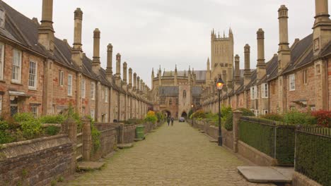 People-strolling-through-Vicars'-Close,-Europe's-oldest-residential-street-with-its-original-buildings-still-preserved