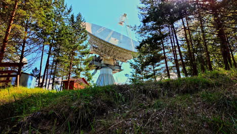 Colorful-view-on-the-Radio-Astronomy-Center-out-of-the-green-forest-on-a-sunny-day,-static-shot,-Ventspils