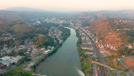 Aerial-view-flyover-the-Paraíba-do-Sul-River,-during-dusk-in-Barra-do-Piraí,-Rio-de-Janeiro,-Brazil