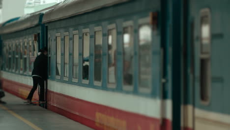 asiatic-female-traveller-carrying-her-trolley-bag-on-the-train-for-journey-across-asia